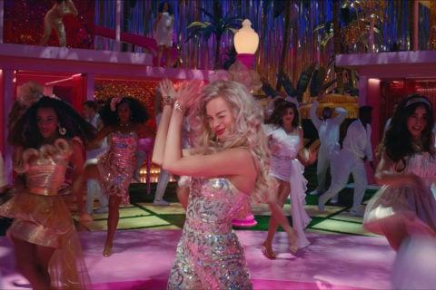 Margot Robbie dancing in the Barbie movie in one of her iconic barbie outfits